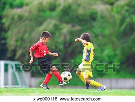 Stock Photo - Japanese kids playing soccer. Fotosearch