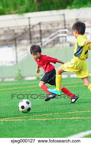 Japanese kids playing soccer View Large Photo Image Stock Photo - Japanese kids playing soccer. Fotosearch