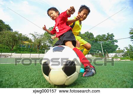 Japanese kids playing soccer View Large Photo Image Stock Photo - Japanese kids playing soccer. Fotosearch