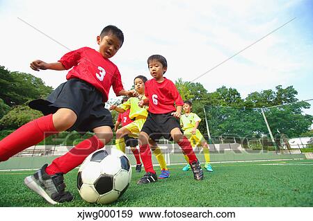 Japanese kids playing soccer View Large Photo Image Stock Photo - Japanese kids playing soccer. Fotosearch