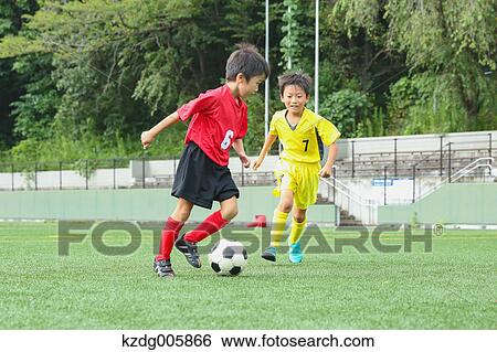 Stock Photograph - Japanese kids playing soccer. Fotosearch