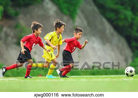 Stock Photograph - Japanese kids playing soccer. Fotosearch