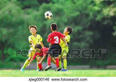 Stock Photograph - Japanese kids playing soccer. Fotosearch