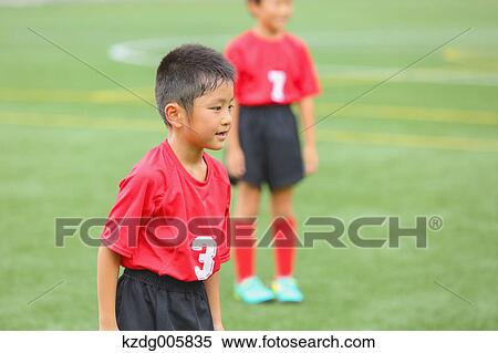 Stock Photography - Japanese kids playing soccer. Fotosearch