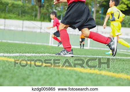 Stock Photography - Japanese kids playing soccer. Fotosearch