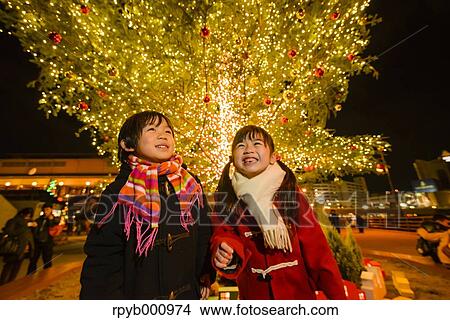 Japanese kids under outdoor Christmas tree View Large Photo Image Picture - Japanese kids under outdoor Christmas tree. Fotosearch