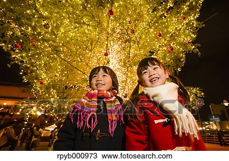 Japanese kids under outdoor Christmas tree View Large Photo Image Stock Image - Japanese kids under outdoor Christmas tree. Fotosearch