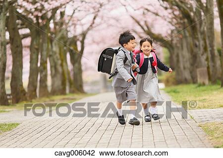 Japanese kids with cherry blossoms in a city park View Large Photo Image Stock Image - Japanese kids with cherry blossoms in a city park. Fotosearch