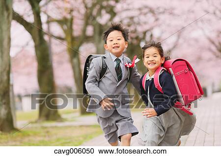 Japanese kids with cherry blossoms in a city park View Large Photo Image Stock Image - Japanese kids with cherry blossoms in a city park. Fotosearch