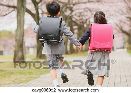 Japanese kids with cherry blossoms in a city park View Large Photo Image Stock Image - Japanese kids with cherry blossoms in a city park. Fotosearch