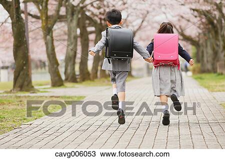 Japanese kids with cherry blossoms in a city park View Large Photo Image Stock Image - Japanese kids with cherry blossoms in a city park. Fotosearch
