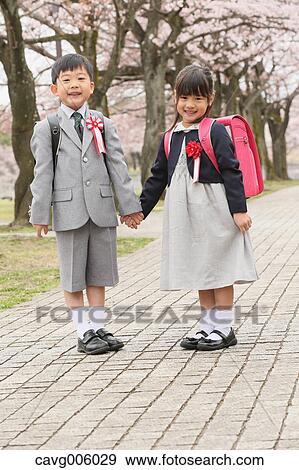 Japanese kids with cherry blossoms in a city park View Large Photo Image Stock Photo - Japanese kids with cherry blossoms in a city park. Fotosearch