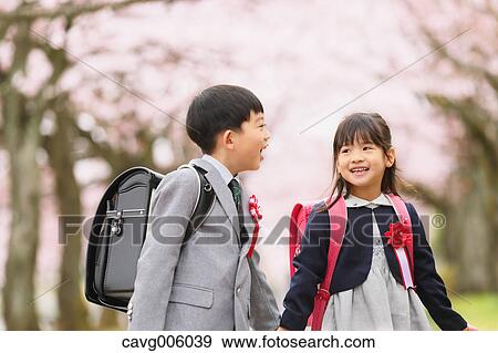 Japanese kids with cherry blossoms in a city park View Large Photo Image Stock Photo - Japanese kids with cherry blossoms in a city park. Fotosearch