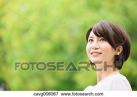 Japanese woman in a city park View Large Photo Image Stock Photo - Japanese woman in a city park. Fotosearch