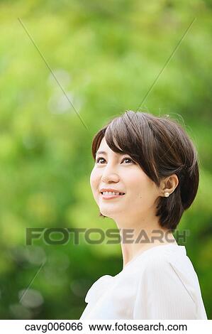Japanese woman in a city park View Large Photo Image Stock Photograph - Japanese woman in a city park. Fotosearch