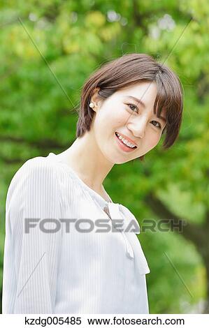 Stock Photography - Japanese woman in a city park. Fotosearch