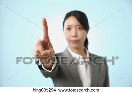 Japanese woman performing touch gesture View Large Photo Image Picture - Japanese woman performing touch gesture. Fotosearch
