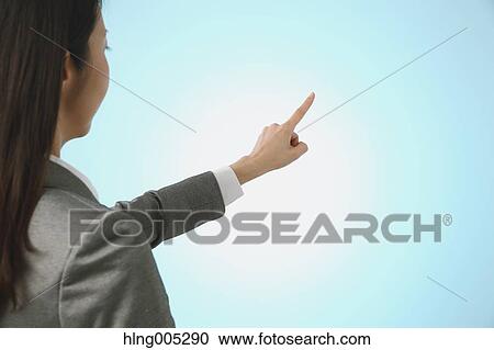 Japanese woman performing touch gesture View Large Photo Image Stock Image - Japanese woman performing touch gesture. Fotosearch