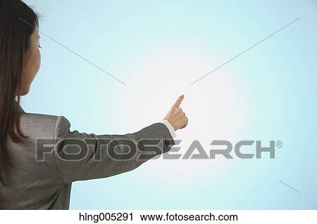 Japanese woman performing touch gesture View Large Photo Image Stock Image - Japanese woman performing touch gesture. Fotosearch