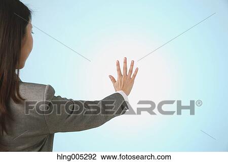 Japanese woman performing touch gesture View Large Photo Image Stock Image - Japanese woman performing touch gesture. Fotosearch