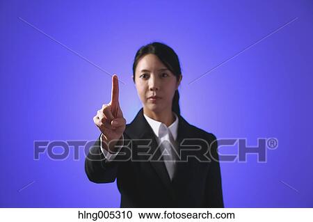 Stock Image - Japanese woman performing touch gesture. Fotosearch