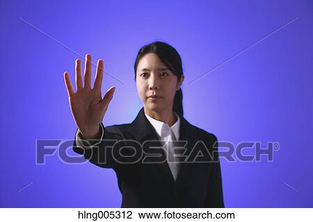 Stock Image - Japanese woman performing touch gesture. Fotosearch