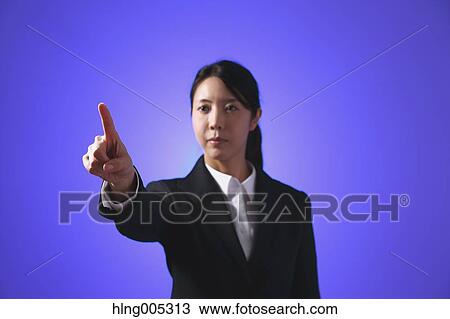Japanese woman performing touch gesture View Large Photo Image Stock Image - Japanese woman performing touch gesture. Fotosearch