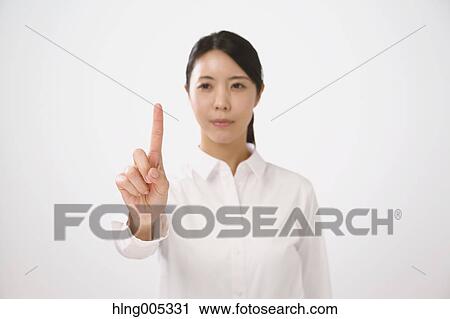 Japanese woman performing touch gesture View Large Photo Image Stock Image - Japanese woman performing touch gesture. Fotosearch