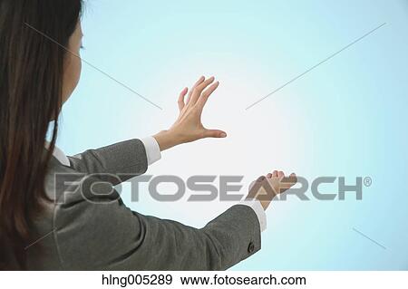 Japanese woman performing touch gesture View Large Photo Image Stock Photo - Japanese woman performing touch gesture. Fotosearch