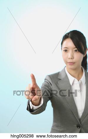 Japanese woman performing touch gesture View Large Photo Image Stock Photo - Japanese woman performing touch gesture. Fotosearch