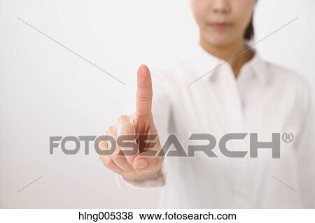 Stock Photo - Japanese woman performing touch gesture. Fotosearch