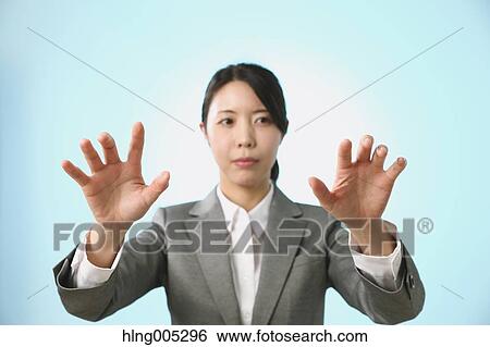Japanese woman performing touch gesture View Large Photo Image Stock Photograph - Japanese woman performing touch gesture. Fotosearch