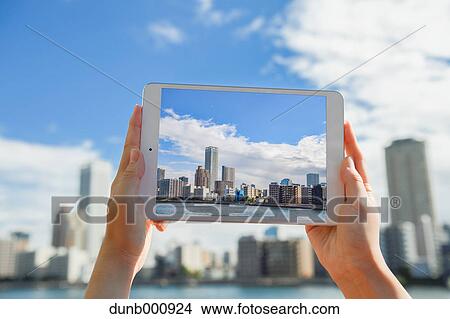 Japanese woman using augumented reality app on tablet downtown Tokyo, Japan View Large Photo Image Picture - Japanese woman using augumented reality app on tablet downtown Tokyo, Japan. Fotosearch