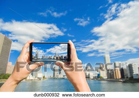 Japanese woman using augumented reality app on smartphone downtown Tokyo, Japan View Large Photo Image Stock Image - Japanese woman using augumented reality app on smartphone downtown Tokyo, Japan. Fotosearch