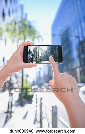Japanese woman using augumented reality app on smartphone downtown Tokyo, Japan View Large Photo Image Stock Image - Japanese woman using augumented reality app on smartphone downtown Tokyo, Japan. Fotosearch