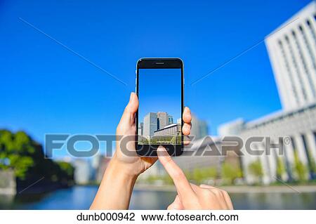 Japanese woman using augumented reality app on smartphone downtown Tokyo, Japan View Large Photo Image Stock Image - Japanese woman using augumented reality app on smartphone downtown Tokyo, Japan. Fotosearch