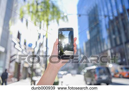 Japanese woman using augumented reality app on smartphone downtown Tokyo, Japan View Large Photo Image Stock Photo - Japanese woman using augumented reality app on smartphone downtown Tokyo, Japan. Fotosearch