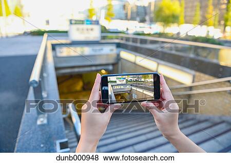 Japanese woman using augumented reality app on smartphone downtown Tokyo, Japan View Large Photo Image Stock Photo - Japanese woman using augumented reality app on smartphone downtown Tokyo, Japan. Fotosearch