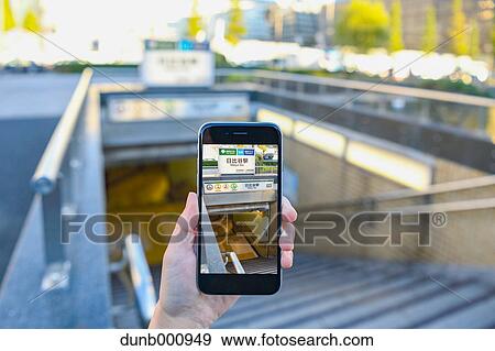 Japanese woman using augumented reality app on smartphone downtown Tokyo, Japan View Large Photo Image Stock Photo - Japanese woman using augumented reality app on smartphone downtown Tokyo, Japan. Fotosearch