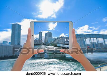 Japanese woman using augumented reality app on tablet downtown Tokyo, Japan View Large Photo Image Stock Photograph - Japanese woman using augumented reality app on tablet downtown Tokyo, Japan. Fotosearch