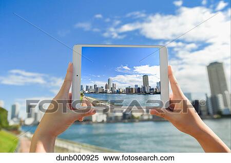 Japanese woman using augumented reality app on tablet downtown Tokyo, Japan View Large Photo Image Stock Photography - Japanese woman using augumented reality app on tablet downtown Tokyo, Japan. Fotosearch