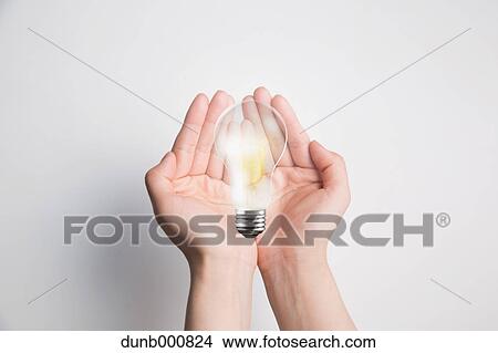 Picture - Japanese woman with light bulb. Fotosearch