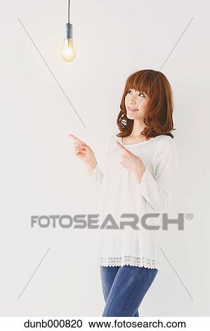 Japanese woman with light bulb View Large Photo Image Stock Image - Japanese woman with light bulb. Fotosearch