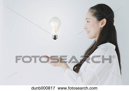 Japanese woman with light bulb View Large Photo Image Stock Photo - Japanese woman with light bulb. Fotosearch