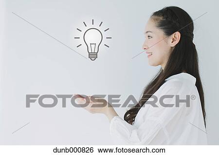 Japanese woman with light bulb View Large Photo Image Stock Photograph - Japanese woman with light bulb. Fotosearch