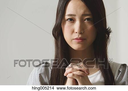 Japanese young woman praying View Large Photo Image Picture - Japanese young woman praying. Fotosearch
