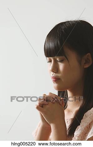 Japanese young woman praying View Large Photo Image Stock Image - Japanese young woman praying. Fotosearch