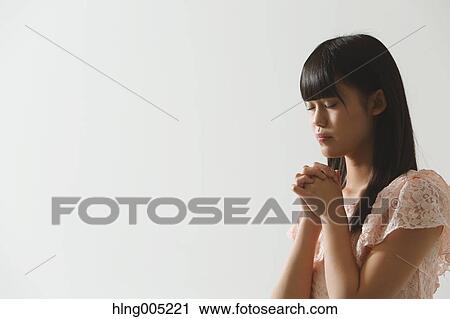 Japanese young woman praying View Large Photo Image Stock Image - Japanese young woman praying. Fotosearch