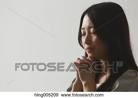 Stock Photo - Japanese young woman praying. Fotosearch