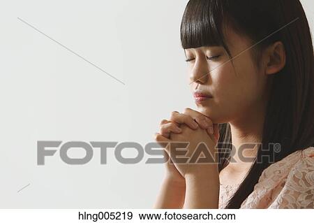 Japanese young woman praying View Large Photo Image Stock Photo - Japanese young woman praying. Fotosearch